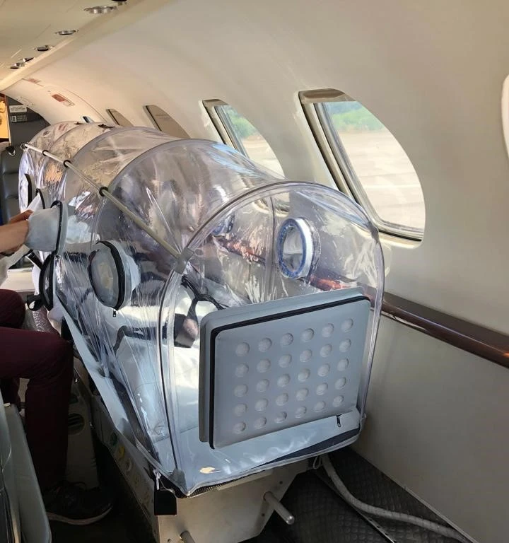 Medical incubator equipment used in air ambulance services for patient transport.