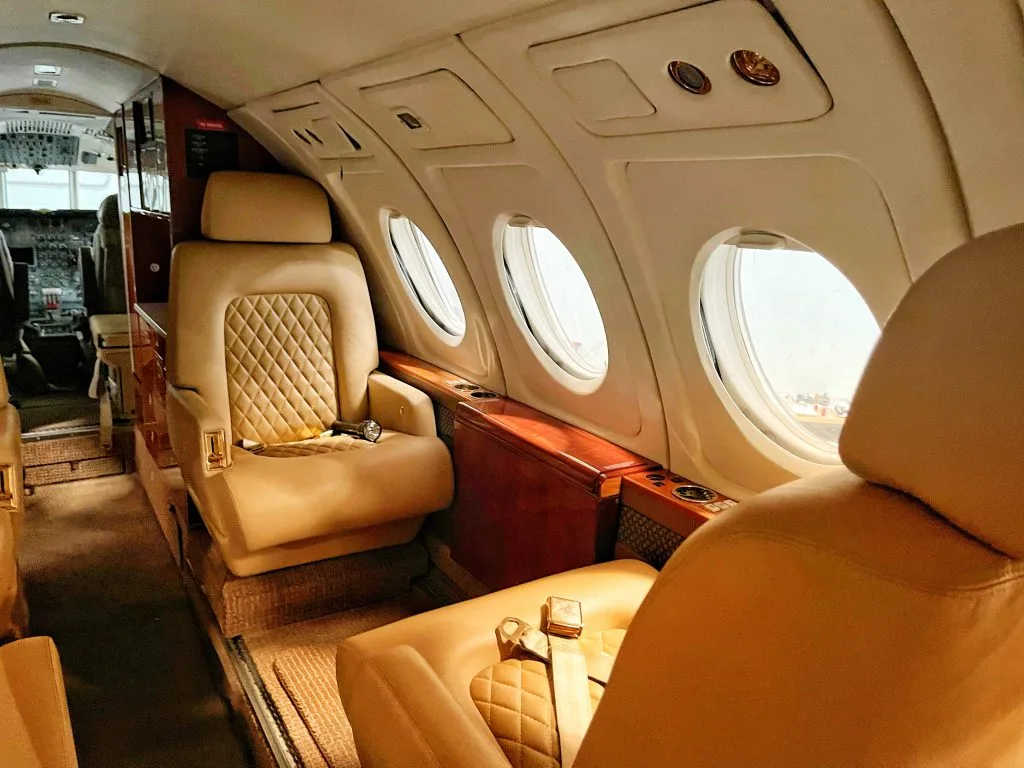 Luxurious leather seat inside a private jet cabin.